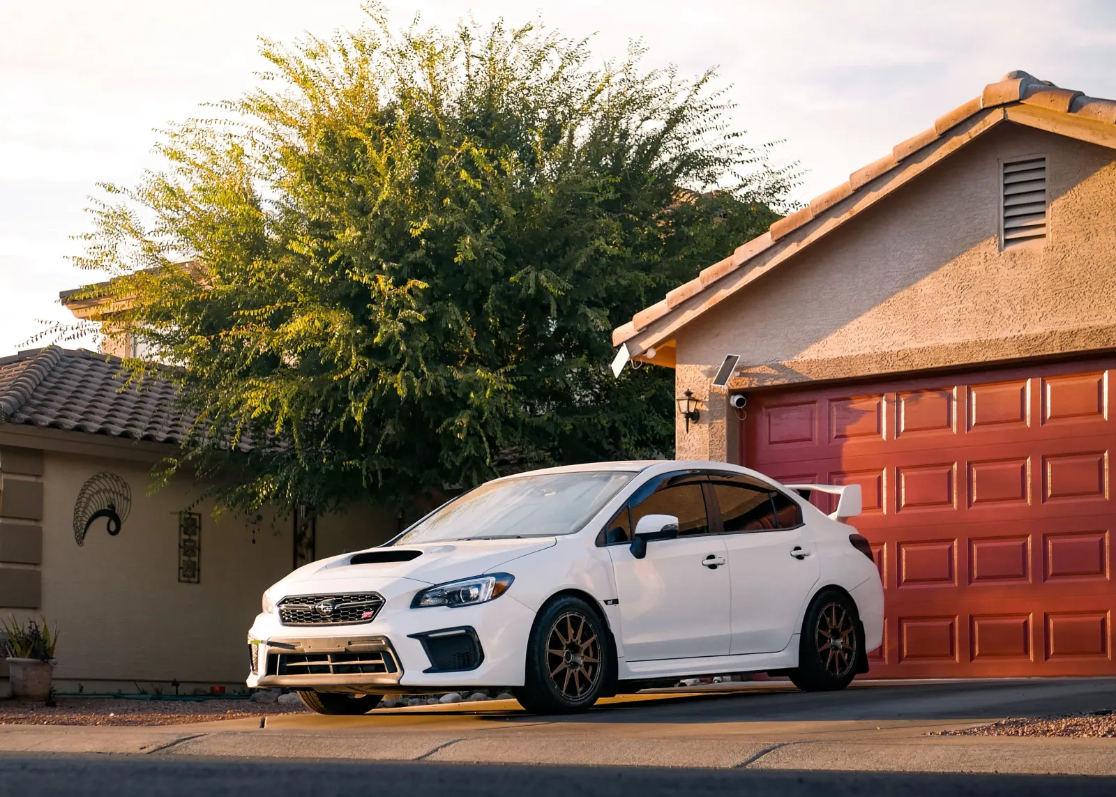 A car parked in a residential driveway, the kind of location where we perform mobile dash cam installations.